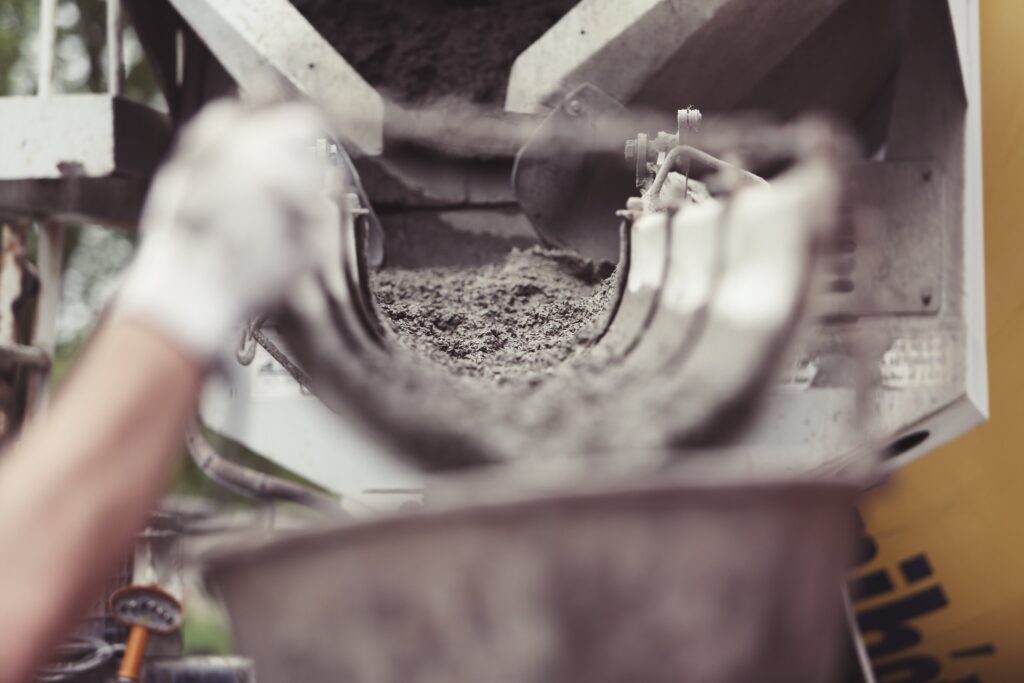 concrete being poured on conveyor belt