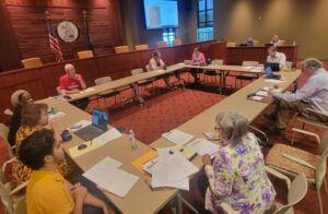 Group of people sitting around a a large table