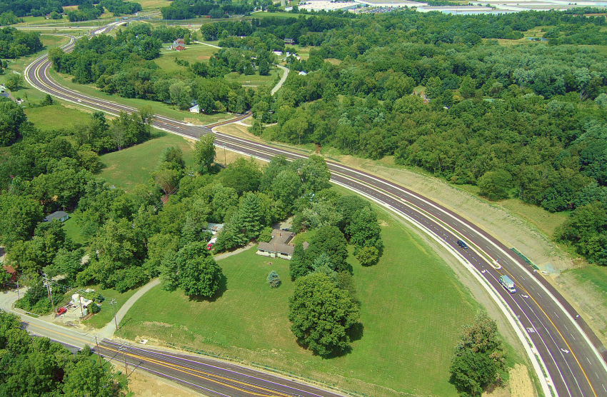 new roadway weaves around forested area