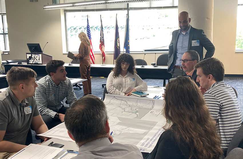 A group of people engaging in public participation at OKI.