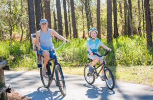 woman and son riding bikes on a trail