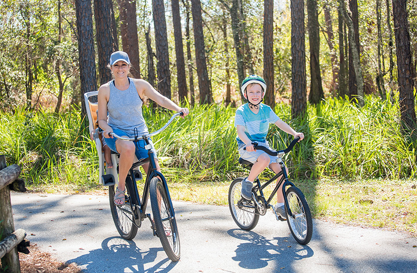woman and son riding bikes on a trail