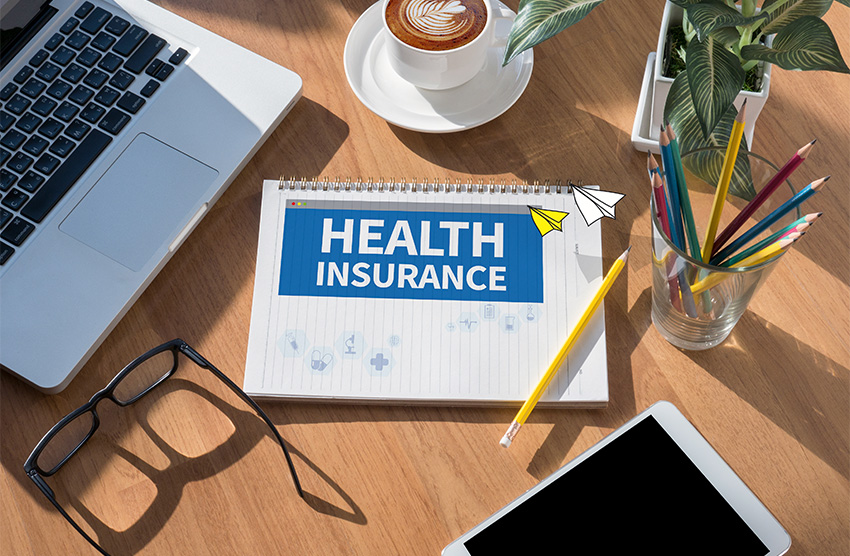 computer with the words health insurance on the screen